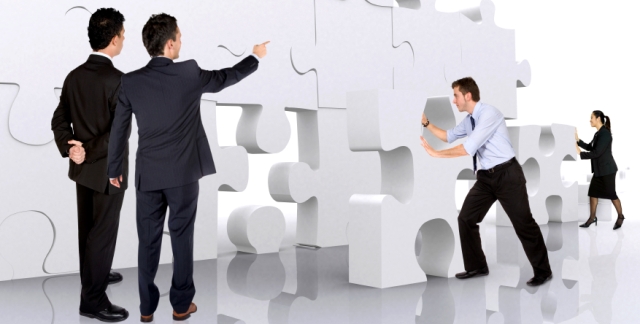 business teamwork - business men making a puzzle